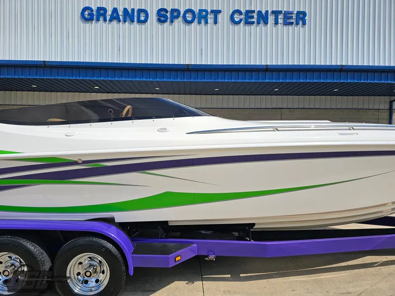Slide: The Image of 2007 Nordic 28 Heat MCOB boat with vibrant green and purple accents at Grand Sport Center. - 5