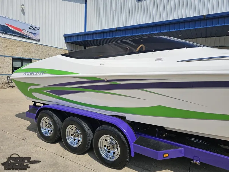 Slide: The Image of Nordic 28 Heat MCOB 2007 boat with green and purple accents on a trailer. - 7