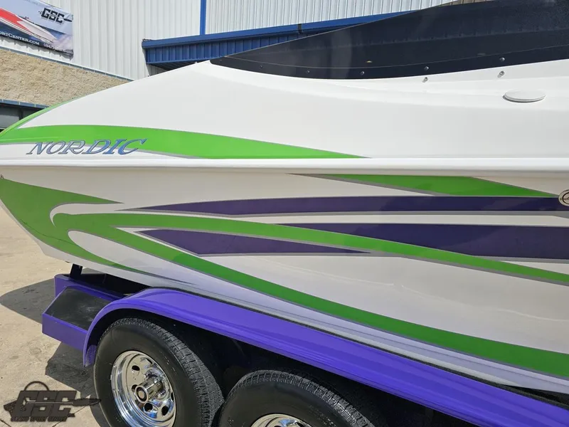 Slide: The Image of Nordic 28 Heat MCOB 2007 boat with green and purple design on a purple trailer. - 8