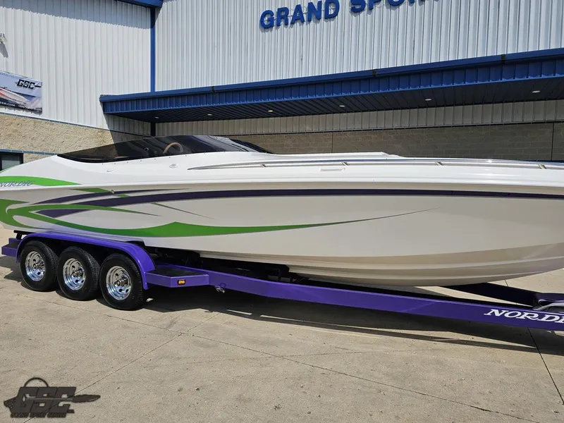 Slide: The Image of 2007 Nordic 28 Heat MCOB boat on purple trailer outside Grand Sport Center. - 9