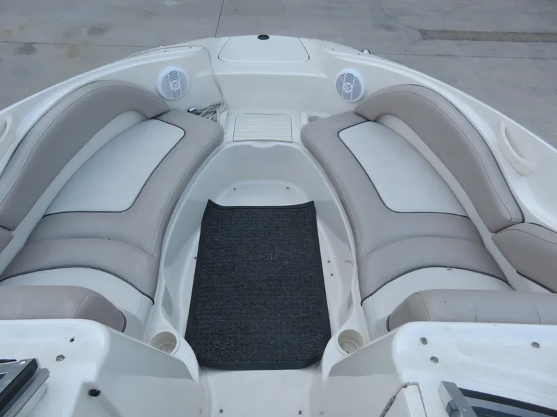 Slide: The Image of 2004 Sea Ray 220 Sundeck interior with cushioned seating and speakers. - 3
