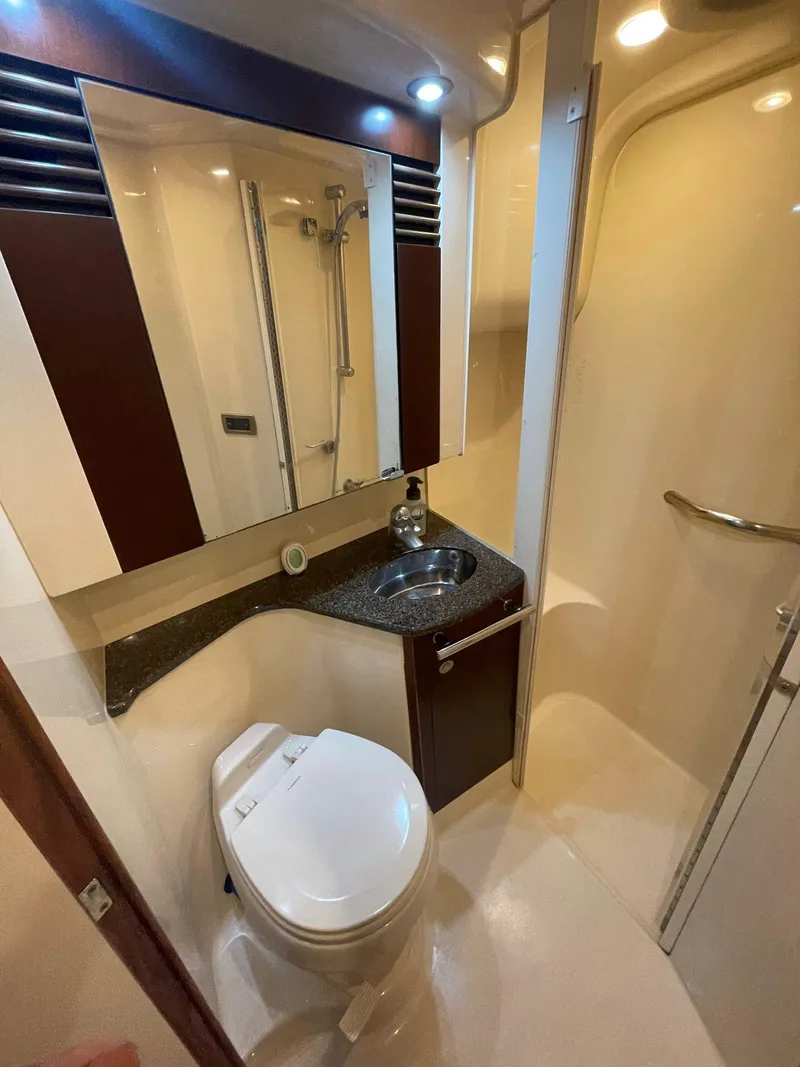 Slide: The Image of Bathroom interior of 2006 Sea Ray 44 Sedan Bridge yacht, featuring sink and toilet. - 14