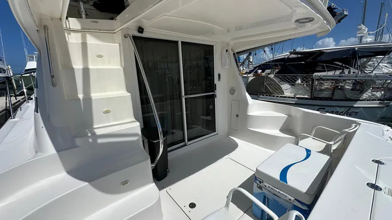 Slide: The Image of 2006 Sea Ray 44 Sedan Bridge yacht deck with seating and sliding door. - 4