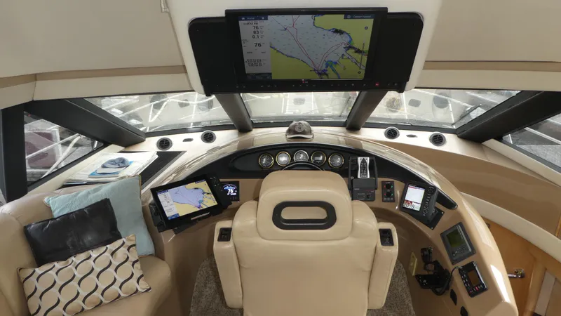 Slide: The Image of 1998 Carver 530 Voyager Pilothouse interior with navigation screens and plush seating. - 18