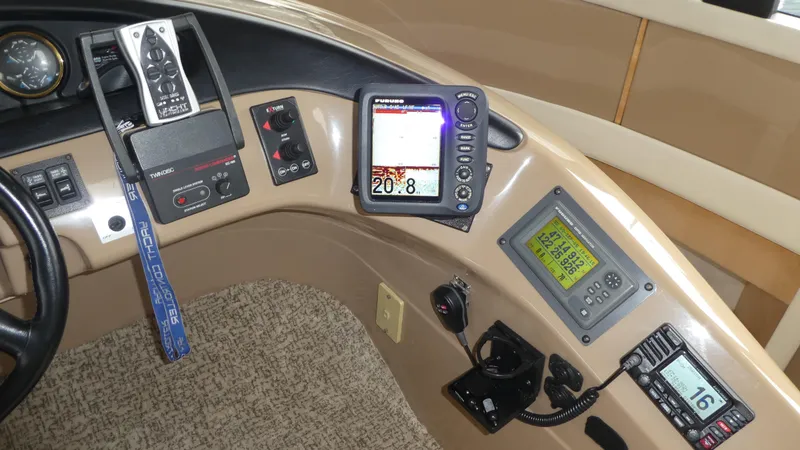 Slide: The Image of 1998 Carver 530 Voyager Pilothouse dashboard with navigation and communication equipment. - 19