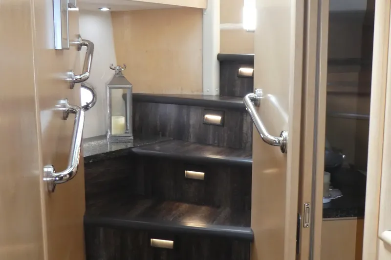 Slide: The Image of Staircase inside 1998 Carver 530 Voyager Pilothouse with elegant wood finish and metal handrails. - 23