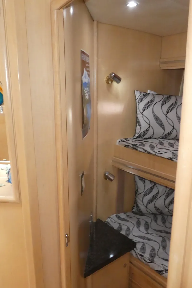 Slide: The Image of 1998 Carver 530 Voyager Pilothouse cabin with bunk beds and modern lighting. - 24