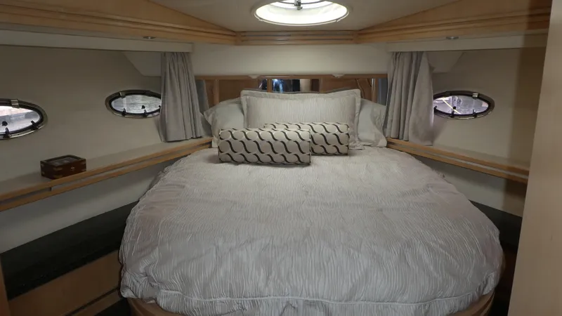 Slide: The Image of Luxurious bedroom in 1998 Carver 530 Voyager Pilothouse yacht with circular bed and porthole windows. - 28