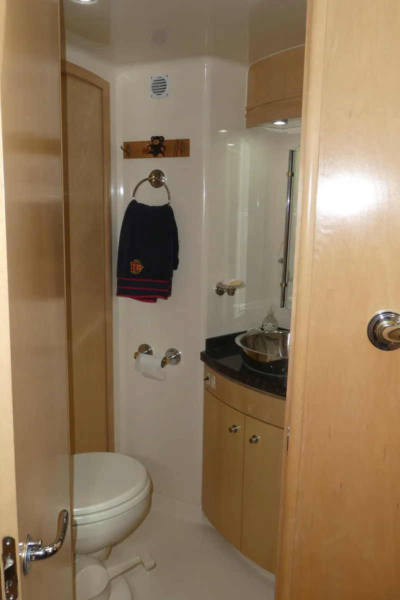 Slide: The Image of 1998 Carver 530 Voyager Pilothouse bathroom with modern fixtures and wooden cabinetry. - 32