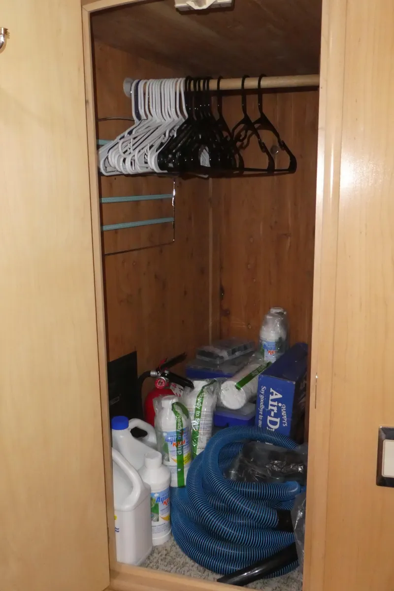 Slide: The Image of Storage closet on a 1998 Carver 530 Voyager Pilothouse with hangers and cleaning supplies. - 37