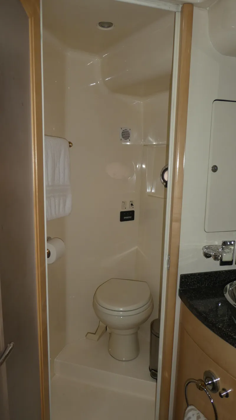 Slide: The Image of 1998 Carver 530 Voyager Pilothouse bathroom with toilet, sink, and towel rack. - 39