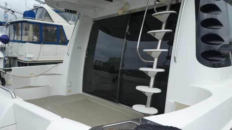 Slide: The Image of 1998 Carver 530 Voyager Pilothouse yacht with spiral staircase and sleek design. - 4
