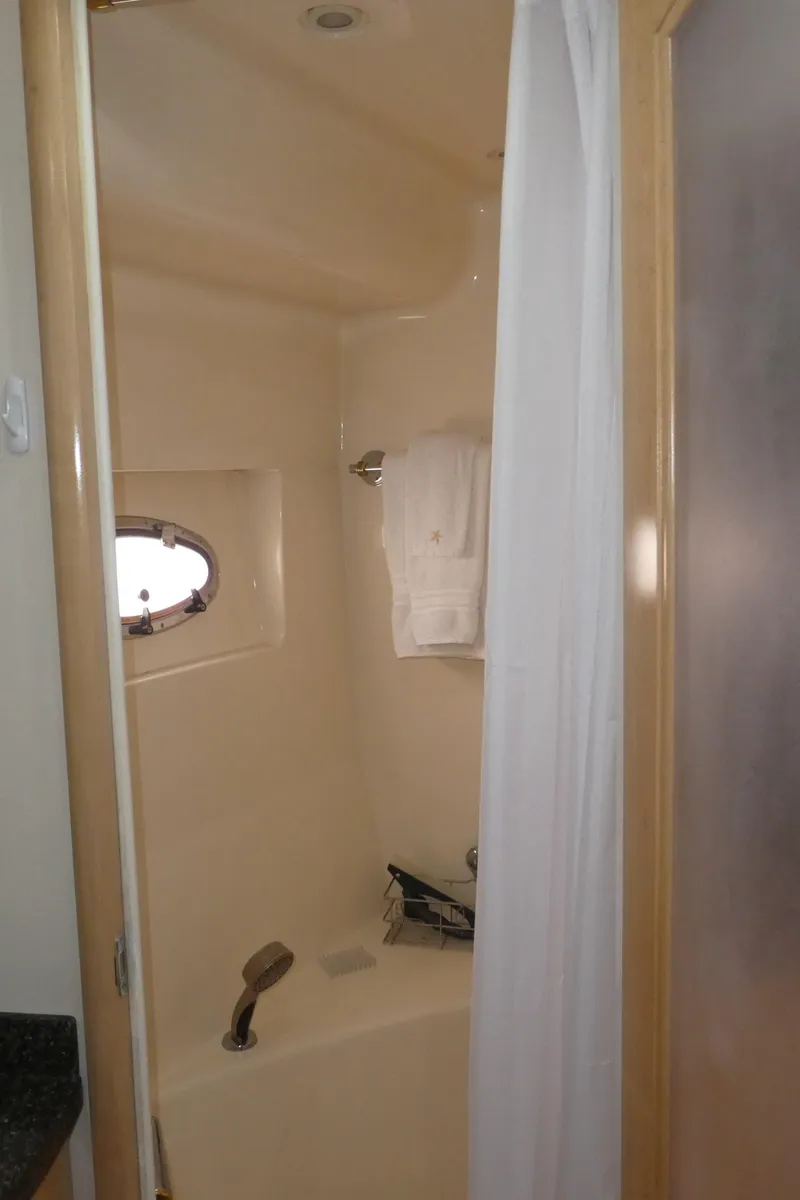 Slide: The Image of 1998 Carver 530 Voyager Pilothouse bathroom with shower and porthole window. - 40