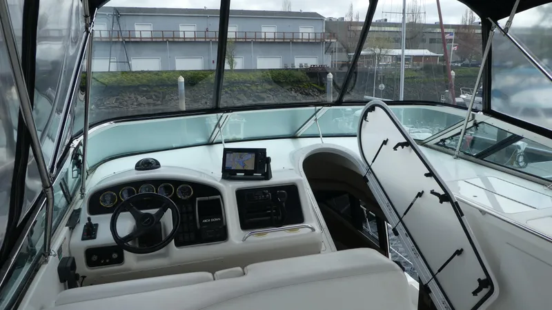 Slide: The Image of 1998 Carver 530 Voyager Pilothouse interior with steering wheel and navigation equipment. - 46