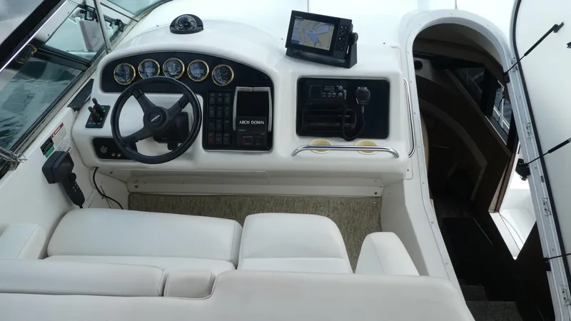 Slide: The Image of 1998 Carver 530 Voyager Pilothouse helm with steering wheel and navigation equipment. - 47