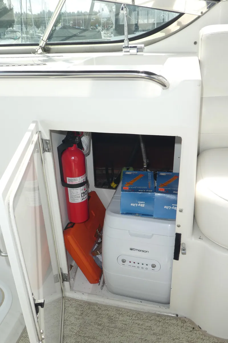 Slide: The Image of 1998 Carver 530 Voyager Pilothouse storage with fire extinguisher and equipment. - 49