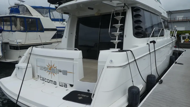 Slide: The Image of 1998 Carver 530 Voyager Pilothouse yacht docked at marina, rear view. - 5