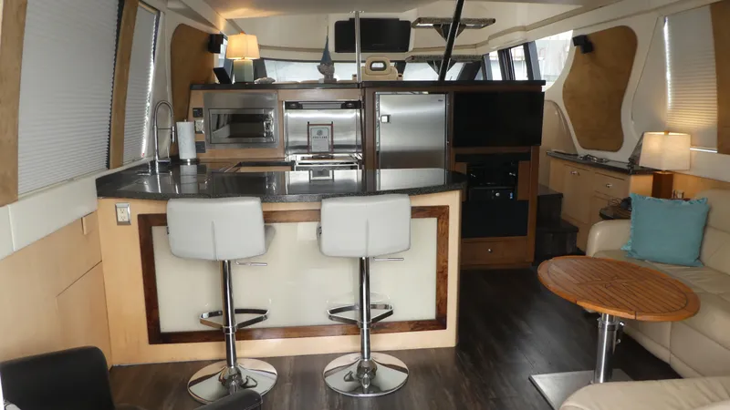 Slide: The Image of Interior of 1998 Carver 530 Voyager Pilothouse with modern kitchen and seating area. - 6