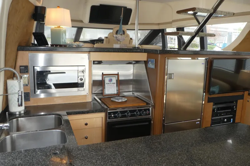 Slide: The Image of Luxurious kitchen interior of 1998 Carver 530 Voyager Pilothouse yacht with modern appliances. - 7