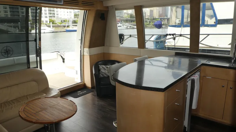Slide: The Image of Interior of 1998 Carver 530 Voyager Pilothouse with modern furnishings and waterfront view. - 9