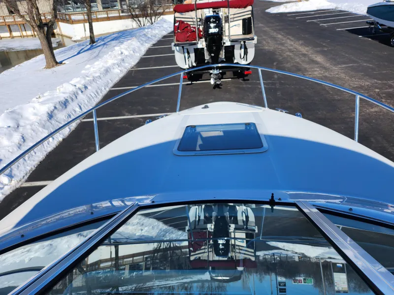 Slide: The Image of 2004 Sea Ray 225 Weekender boat on trailer in snowy parking lot. - 13
