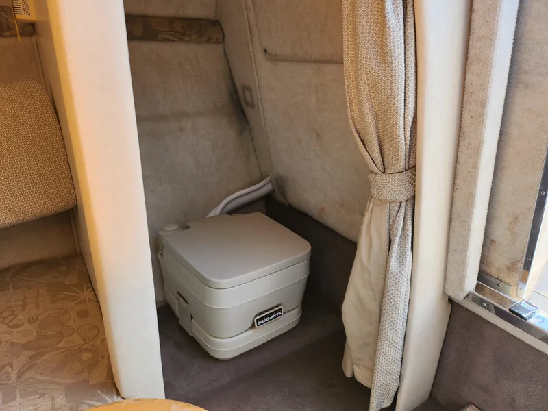 Slide: The Image of Interior of 2004 Sea Ray 225 Weekender with portable toilet and privacy curtain. - 16