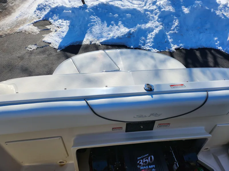 Slide: The Image of 2004 Sea Ray 225 Weekender boat with snow-covered surroundings, showcasing engine compartment. - 22