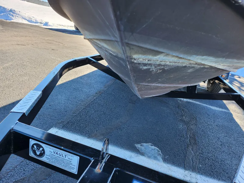 Slide: The Image of 2004 Sea Ray 225 Weekender boat on trailer, showing hull and trailer details. - 7