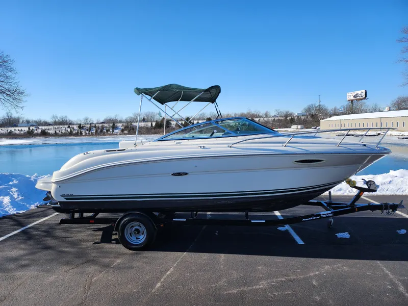 Slide: The Image of 2004 Sea Ray 225 Weekender boat on trailer by a snowy lakeside. - 9