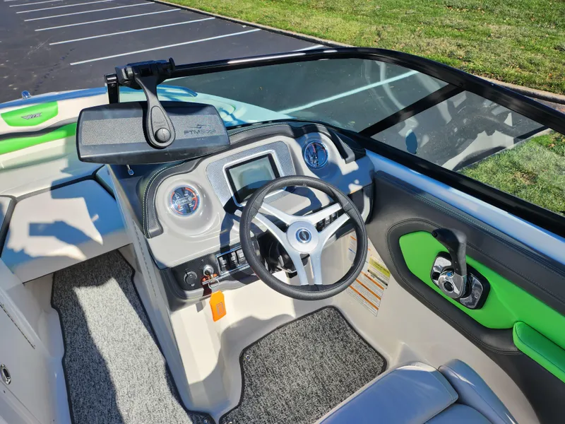 Slide: The Image of 2016 Chaparral Vortex 203 VRX boat cockpit with steering wheel and dashboard controls. - 12