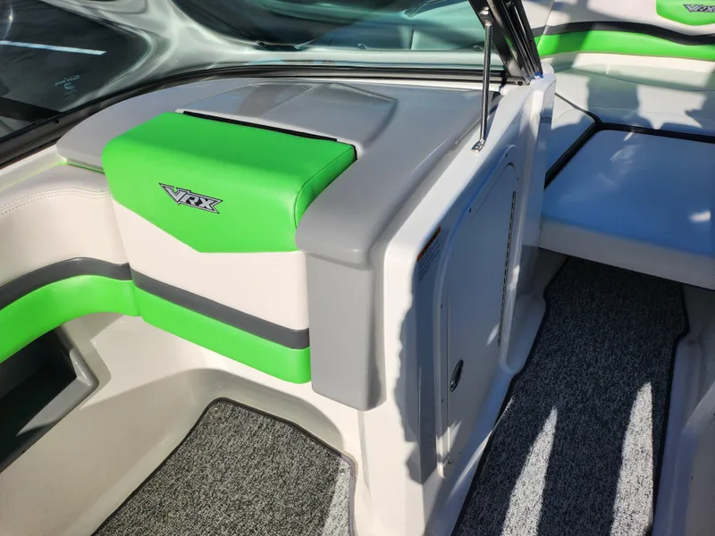 Slide: The Image of 2016 Chaparral Vortex 203 VRX interior with green and gray seating. - 14