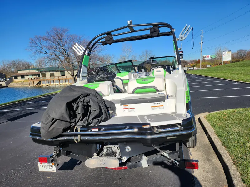 Slide: The Image of 2016 Chaparral Vortex 203 VRX boat parked on a sunny day near a lake. - 2