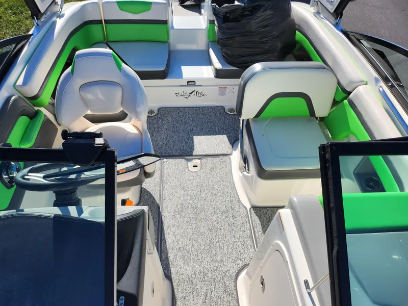 Slide: The Image of 2016 Chaparral Vortex 203 VRX boat interior with green and white seating. - 20