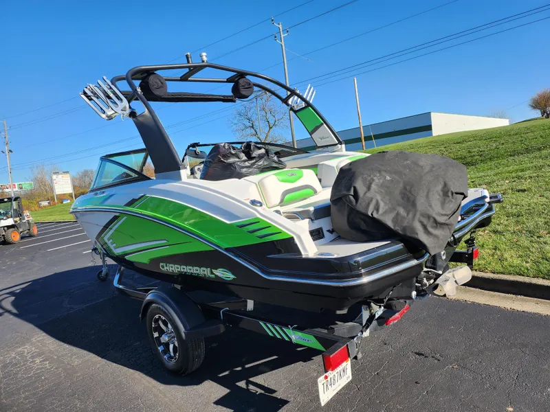 Slide: The Image of 2016 Chaparral Vortex 203 VRX boat with green accents parked outdoors. - 3