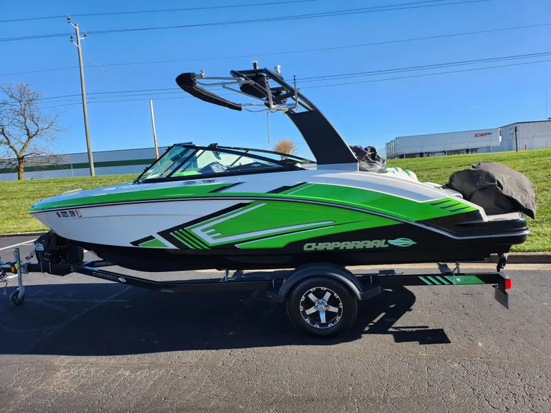 Slide: The Image of 2016 Chaparral Vortex 203 VRX boat with green accents on a trailer, parked outdoors. - 4