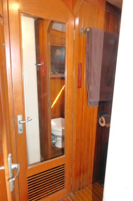 Slide: The Image of 1978 Brewer 45 Ketch bathroom with wooden interior and mirror. - 12