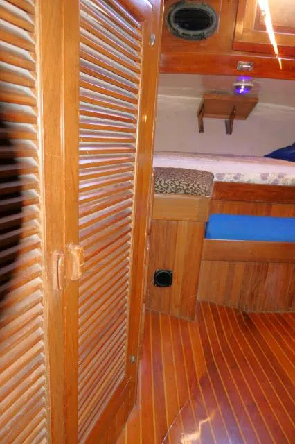 Slide: The Image of Interior of 1978 Brewer 45 Ketch with wooden finishes and cozy cabin space. - 14