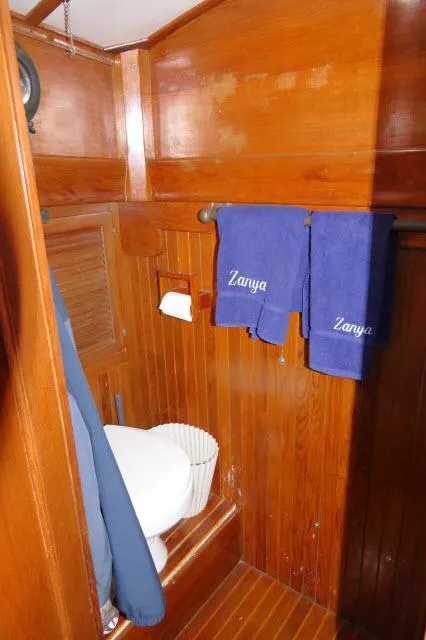 Slide: The Image of 1978 Brewer 45 Ketch bathroom with wooden interior and blue towels. - 20