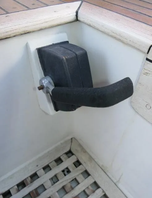 Slide: The Image of 1978 Brewer 45 Ketch boat handle in cockpit, featuring wooden and metal elements. - 28