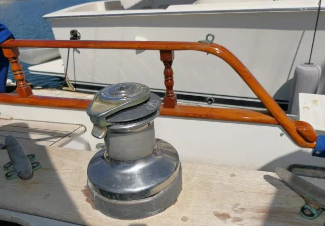 Slide: The Image of Winch on 1978 Brewer 45 Ketch sailboat deck, with wooden railing in background. - 29