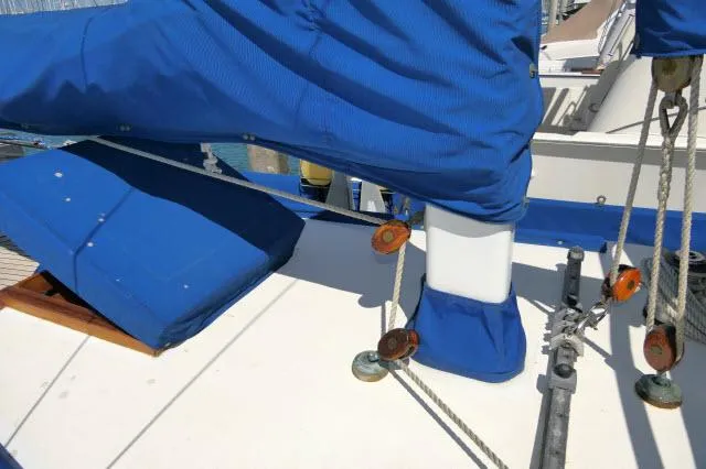 Slide: The Image of 1978 Brewer 45 Ketch sailboat deck with blue covers and rigging details. - 31