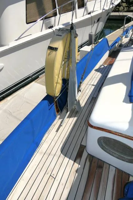 Slide: The Image of 1978 Brewer 45 Ketch deck with blue cover and life preserver. - 33