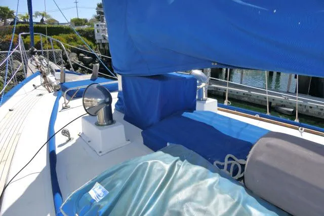Slide: The Image of 1978 Brewer 45 Ketch sailboat deck with blue covers and dockside view. - 38