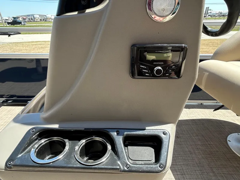 Slide: The Image of 2023 Sun Tracker BB 18 DLX boat console with stereo and cup holders. - 3