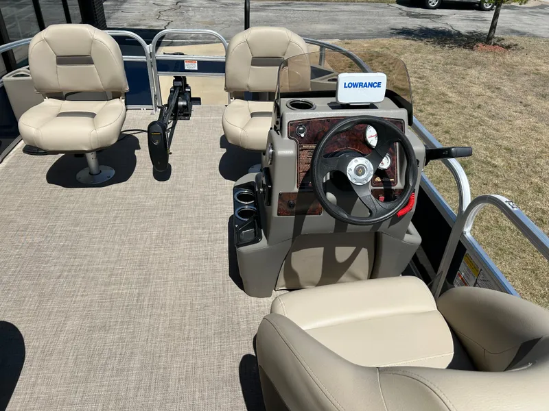 Slide: The Image of 2023 Sun Tracker BB 18 DLX pontoon boat interior with steering console and seating. - 6
