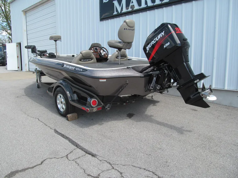 Slide: The Image of 2005 Ranger 185 VX boat with Mercury engine, parked outside a building. - 3