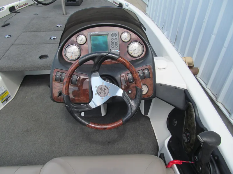 Slide: The Image of 2005 Ranger 185 VX boat dashboard with wood accents and modern gauges. - 6