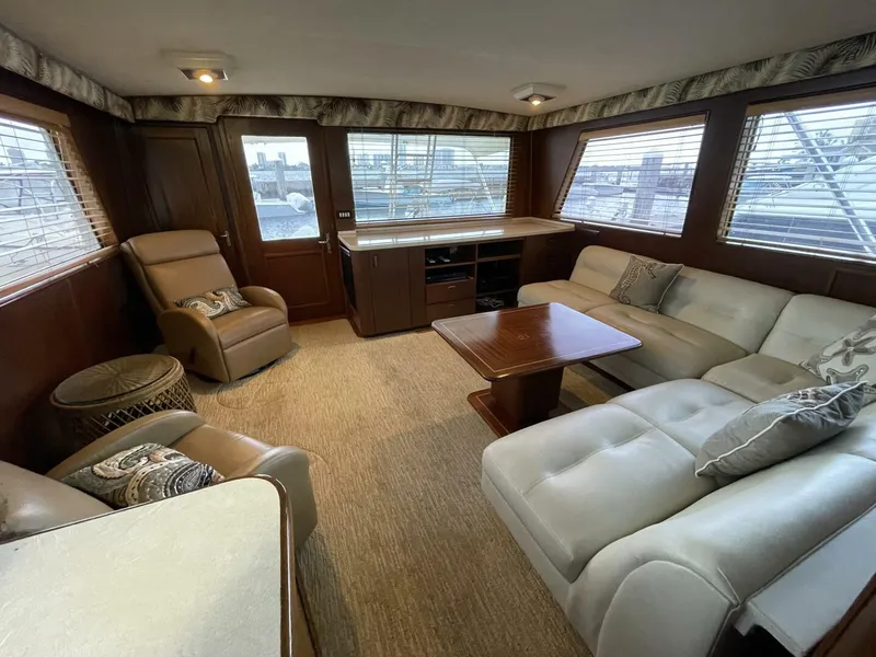 Slide: The Image of Luxurious interior of a 1985 Hatteras Enclosed Bridge yacht with plush seating and wood accents. - 2