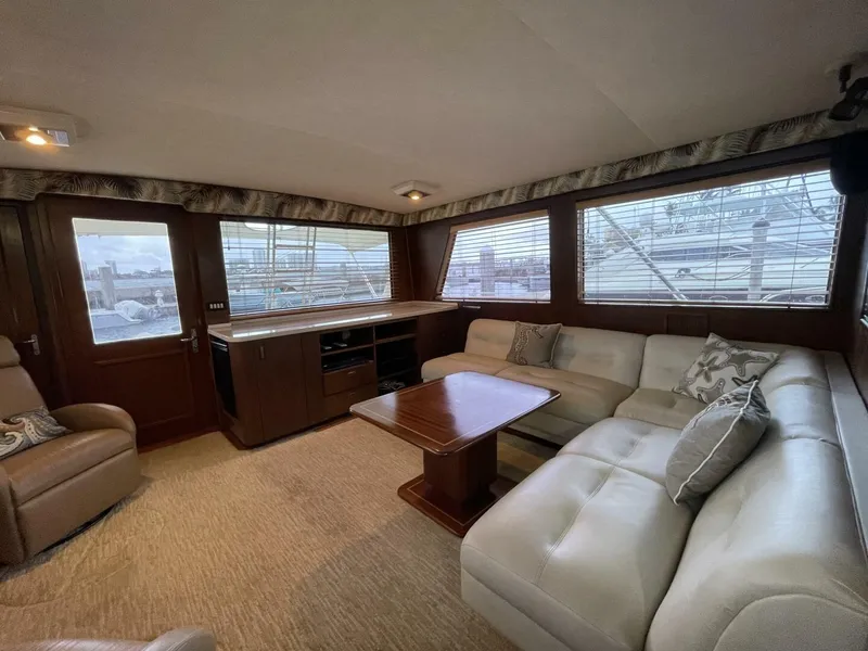 Slide: The Image of Luxurious interior of 1985 Hatteras Enclosed Bridge yacht with plush seating and wooden accents. - 3