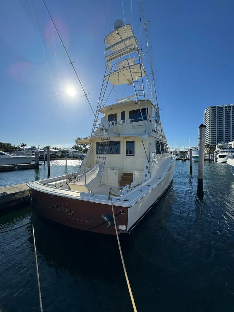 Slide: The Image of 1985 Hatteras Enclosed Bridge yacht docked in sunny marina, showcasing elegant design. - 30